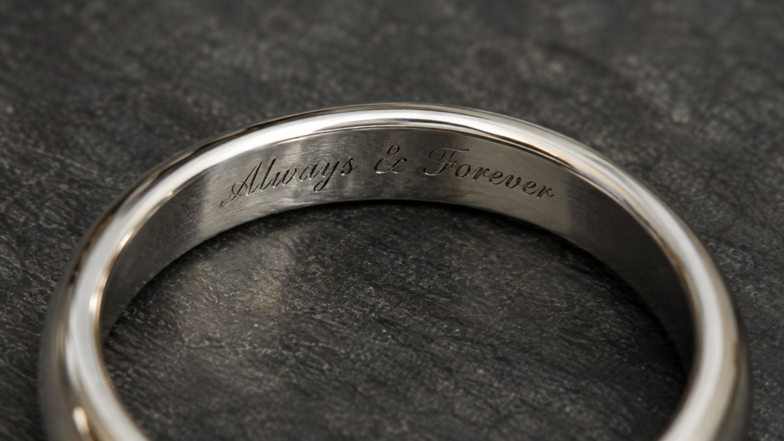 Custom diamond engraving with laser-engraved script inside a ring band