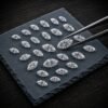 High quality lab created marquise diamonds featuring a large center stone held by tweezers.