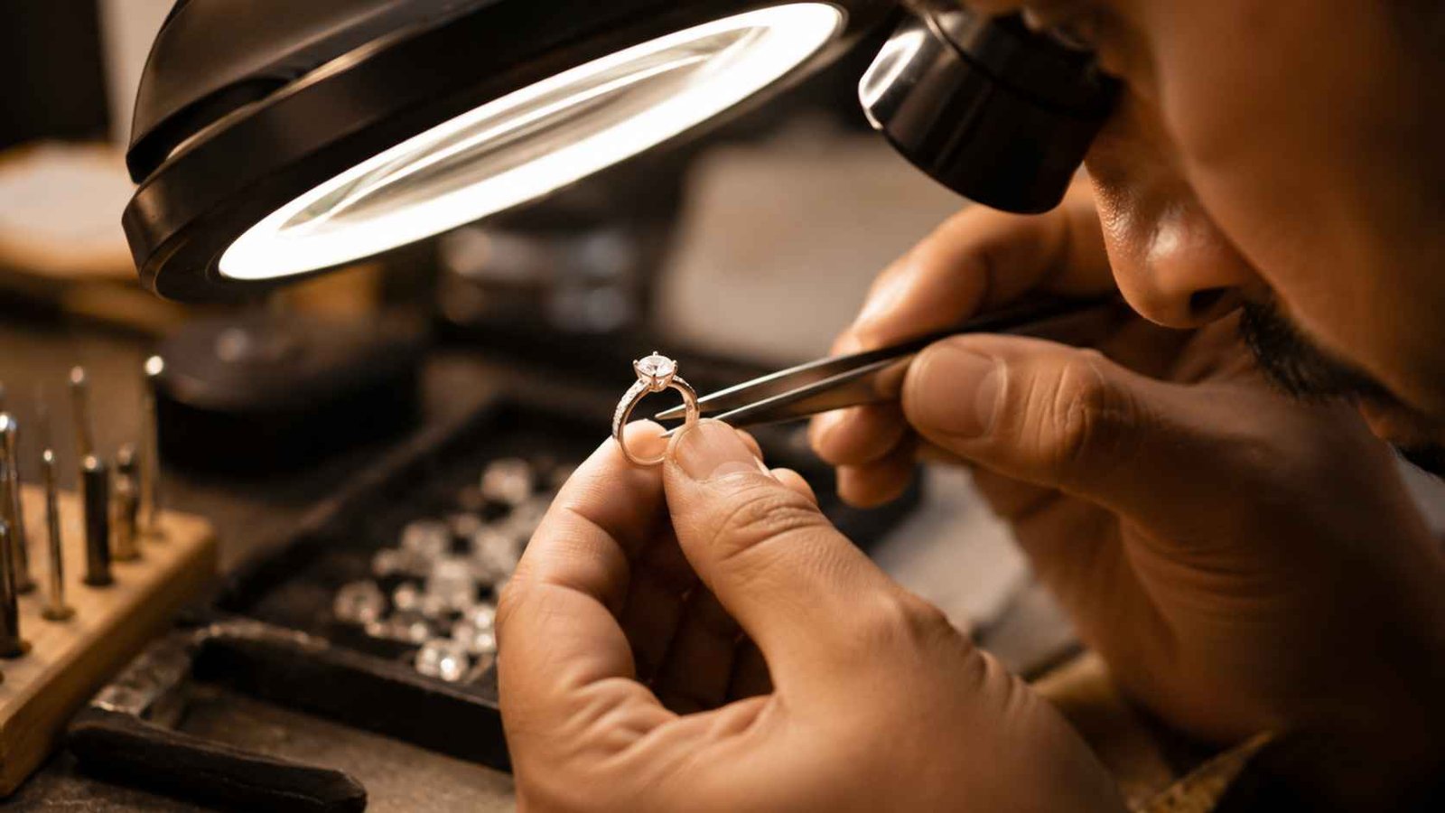 Jeweller inspecting a diamond ring setting under magnification