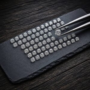 Bulk loose cushion cut diamonds in a precise grid layout for custom jewelry manufacturing.
