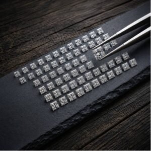 High quality lab created square princess cut diamond held by jeweler tweezers for quality inspection.