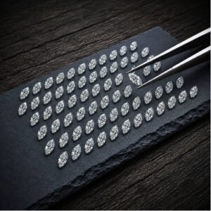 Wholesale loose marquise cut lab grown diamonds arranged in rows on a black stone tray.